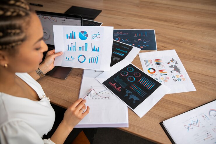 office-workers-using-finance-graphs_23-2150408674.jpg